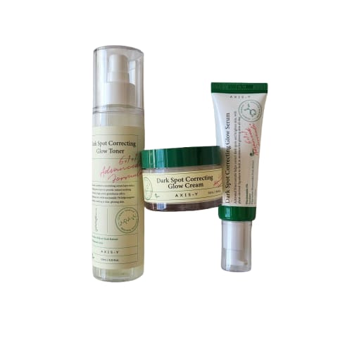 Set of skincare products including a toner, cream, and serum.