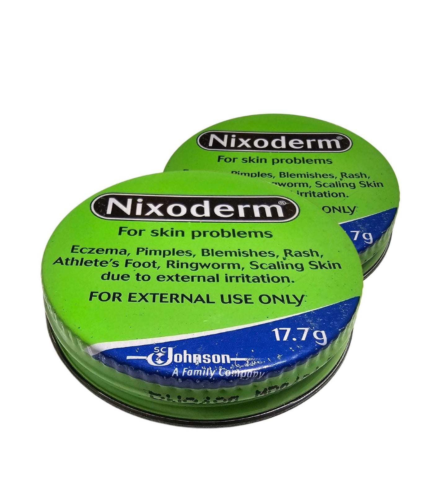 Two green containers of Nixoderm for skin treatment on a white background