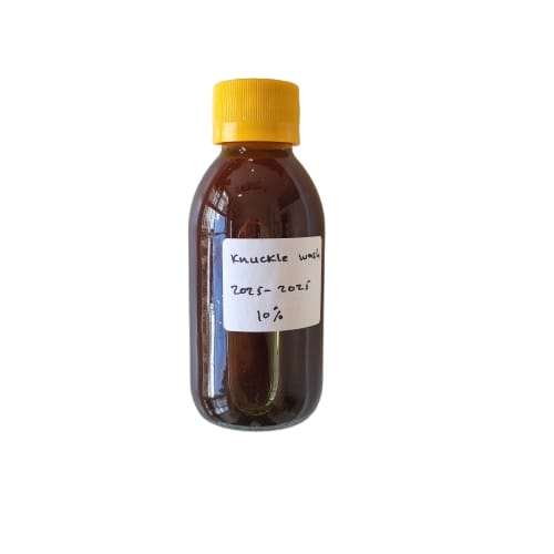 Bottle of Kukule syrup with a yellow cap on a white background