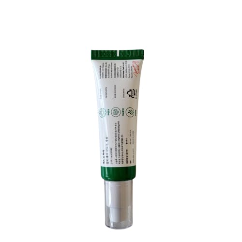 Tube of cream with green cap on a white background